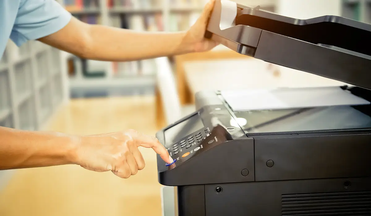 Office staff using a rented photocopier instead of buying in Mussafah